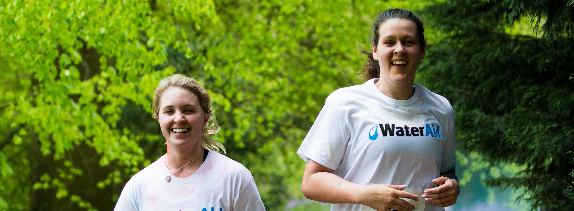 Two students running together in a Park