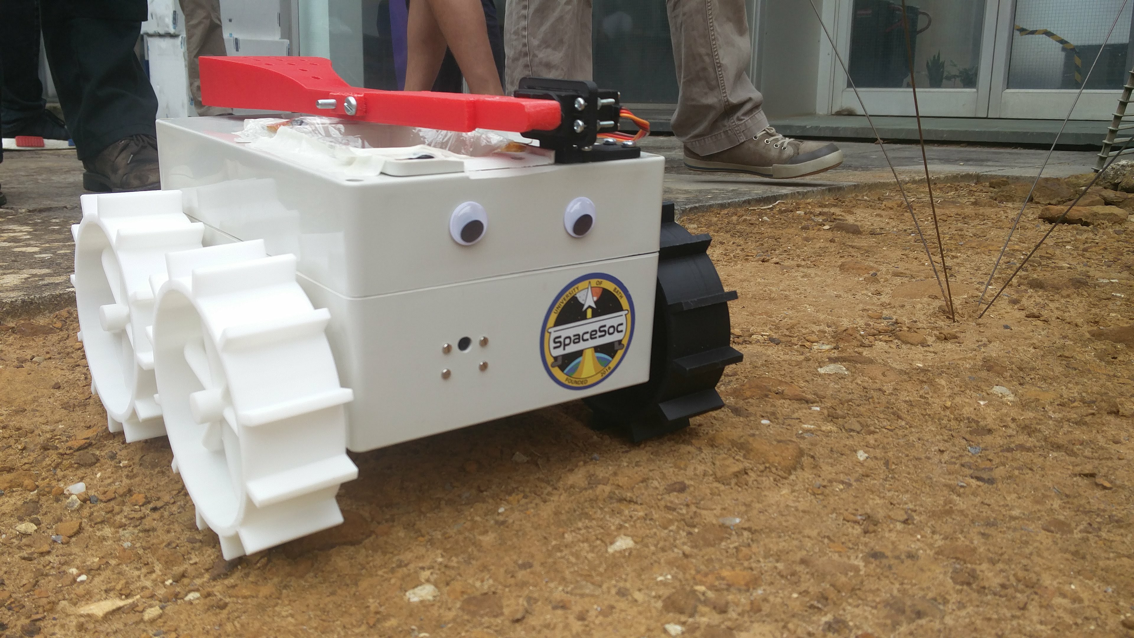 The rover has googly eyes, a SpaceSoc sticker and four paddle wheels to grip on the red sand.